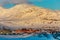 Rows of colorful Inuit houses with Little Malene mountain in the