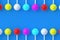 Rows of colorful lollipops on stick on blue background. Sweet candy. Confectionery goods. Top view. Copy space