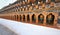 Rows of colorful religious prayer wheels in Paro Rinpung Dzong.