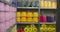 Rows of colorful thread bobbins on rack shelves closeup