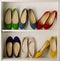Rows of colorful women`s shoes ballet shoes in the wardrobe.