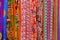 Rows of colourful silk scarfs hanging at a market stall in Thailand