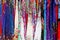 Rows of colourful silk scarfs hanging at a market stall in Thailand