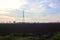 Rows of electricity pylons and power lines over cultivated fields on a winter day in the italian countryside