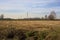 Rows of electricity pylons and power lines over cultivated fields on a winter day in the italian countryside