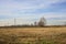 Rows of electricity pylons and power lines over cultivated fields on a winter day in the italian countryside