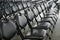 Rows of empty black folding chairs