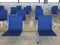 Rows of empty blue seats in airport terminal. Contemporary lounge with seats in the airport, blue tone. Bench in the terminal of
