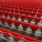Rows of empty bright plastic chairs, seats of tribune on stadium, diagonal background