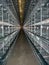 Rows of empty cages from inside an industrial chicken egg layer confinement building.