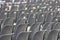 Rows of empty dark chairs. Abstract. Back view