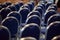 Rows of empty metal chairs in a large assembly hall.Empty chairs in conference hall.Interior meeting room. Back view