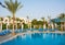 Rows of empty sunbeds near the swimming pool at dawn at the hotel