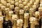Rows of golden necks of champagne bottles. Traditional holidays, Christmas and New Year. Close-up. Selective focus