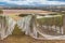 Rows of grape vines covered with bird netting and countryside