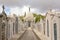 Rows of graves and chapel with bronze statue of mourning woman on top