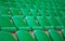 rows of green tribunes in a huge stadium