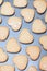 Rows of heart shaped biscuits on metal baking tray