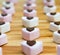 Rows of heart shaped marshmallow and chocolate sweets.