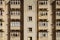 Rows of identical stone coloured wooden Maltese traditional balconies in harsh sunlight. Valletta social housing