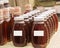 Rows of jars with amber colored honey.