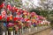 Rows jizo statues with red bibs, hats, flower and colorful wind mills at Zojoji temple in Tokyo, Japan. it represent the children