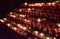 Rows of lighted candles in a church during a Christmas service