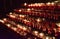 Rows of lighted candles in a church during a Christmas service