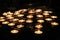 Rows of lit candles, casting soft shadows in room of prayer