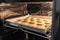 Rows of macaroons being home baked in a hot oven.