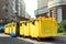 Rows of many big plastic yellow dumpster cans full of black plastic trash litter bags near residential building at city