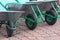 Rows of metal wheelbarrows with black wheels