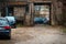 Rows of modern cars in the narrow yard of an old residential area