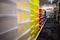 Rows of multi-colored storage bin totes in a retail store shelving space.