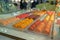 Rows of multicolored macaroons in a bakery window