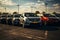 Rows of new cars parked in a dealership parking lot for sales, automotive industry