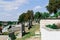 Rows of old abandoned graves in a Catholic cemetery. The rickety gravestones