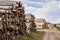 Rows of piled of logs , waiting to be processed, at a local rural lumber mill, made into lumber for construction