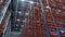 Rows of racks with red planks in storehouse low angle shot