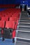 Rows of red and blue seats, entrance and stairs in auditorium