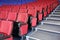 Rows of red and blue seats and stairs in auditorium