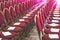 Rows of red chairs in conference hall, empty meeting or event room. Empty guest seats