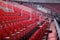 Rows of red numbered seats with armrests