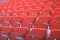 Rows of red numbered seats with armrests