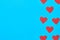 Rows of red paper hearts on blue background. Concept of Valentines Day. Space for text