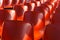 Rows of red plastic chairs