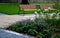 Rows of reddish wood benches on their paneling under the benches is a rectangle of concrete anti-scraping beige paths by the shoes