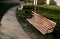 Rows of reddish wood benches on their paneling under the benches is a rectangle of concrete anti-scraping beige paths by the shoes