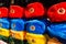 Rows of russian winter hats of different colors with army emblems at the street market at Old Arbat street