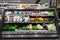 Rows and shelves of grocery department with fresh greenery and vegetables